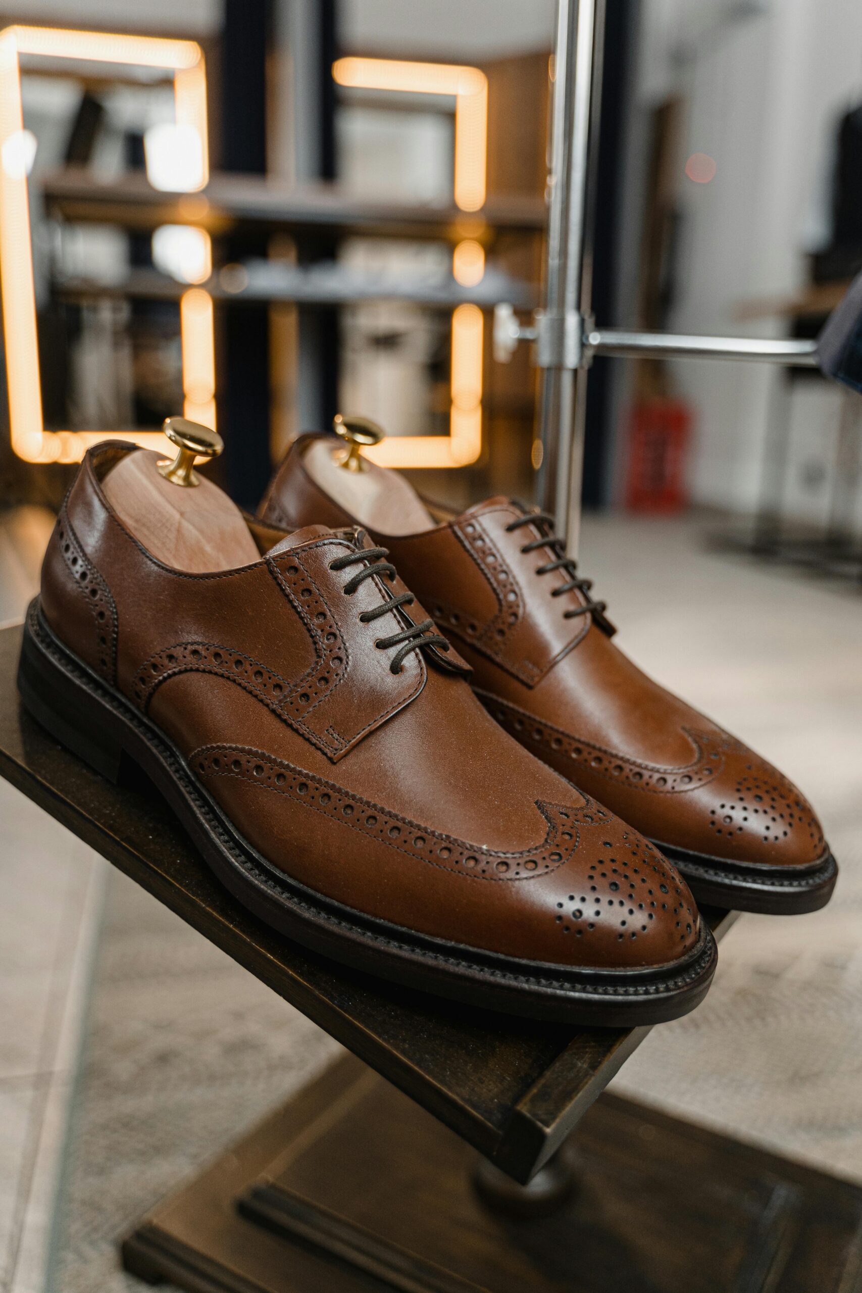 Pair of classic brown leather brogue shoes showcased in a stylish setting.
